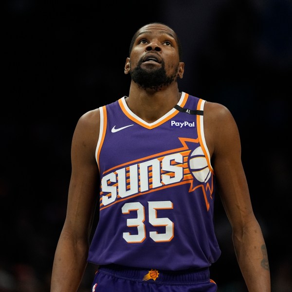 Phoenix Suns forward Kevin Durant (35) looks to the scoreboard during the second half of an NBA basketball game against the Charlotte Hornets in Charlotte, N.C., Tuesday, Jan. 7, 2025. (AP Photo/Jim Dedmon)