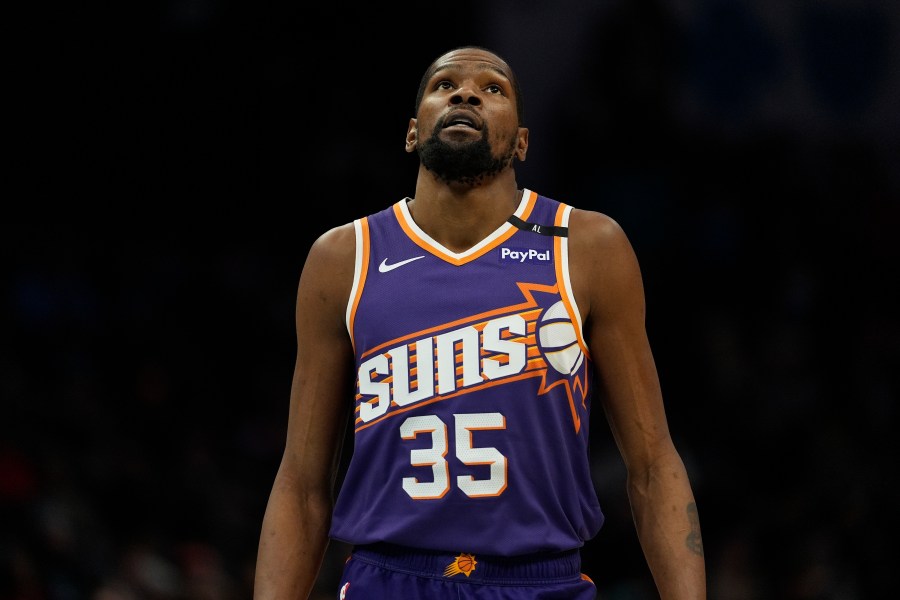 Phoenix Suns forward Kevin Durant (35) looks to the scoreboard during the second half of an NBA basketball game against the Charlotte Hornets in Charlotte, N.C., Tuesday, Jan. 7, 2025. (AP Photo/Jim Dedmon)