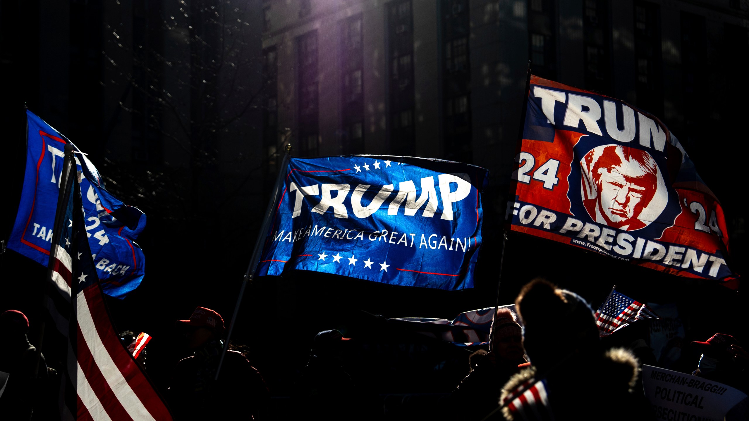 Demonstrators wave Trump flags outside Manhattan criminal court following the sentencing in President-elect Donald Trump's hush money case in New York, Friday, Jan. 10, 2025. (AP Photo/Julia Demaree Nikhinson)