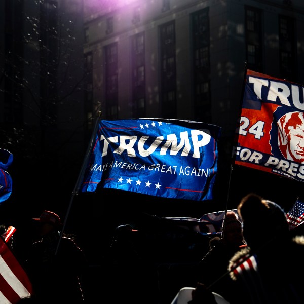 Demonstrators wave Trump flags outside Manhattan criminal court following the sentencing in President-elect Donald Trump's hush money case in New York, Friday, Jan. 10, 2025. (AP Photo/Julia Demaree Nikhinson)