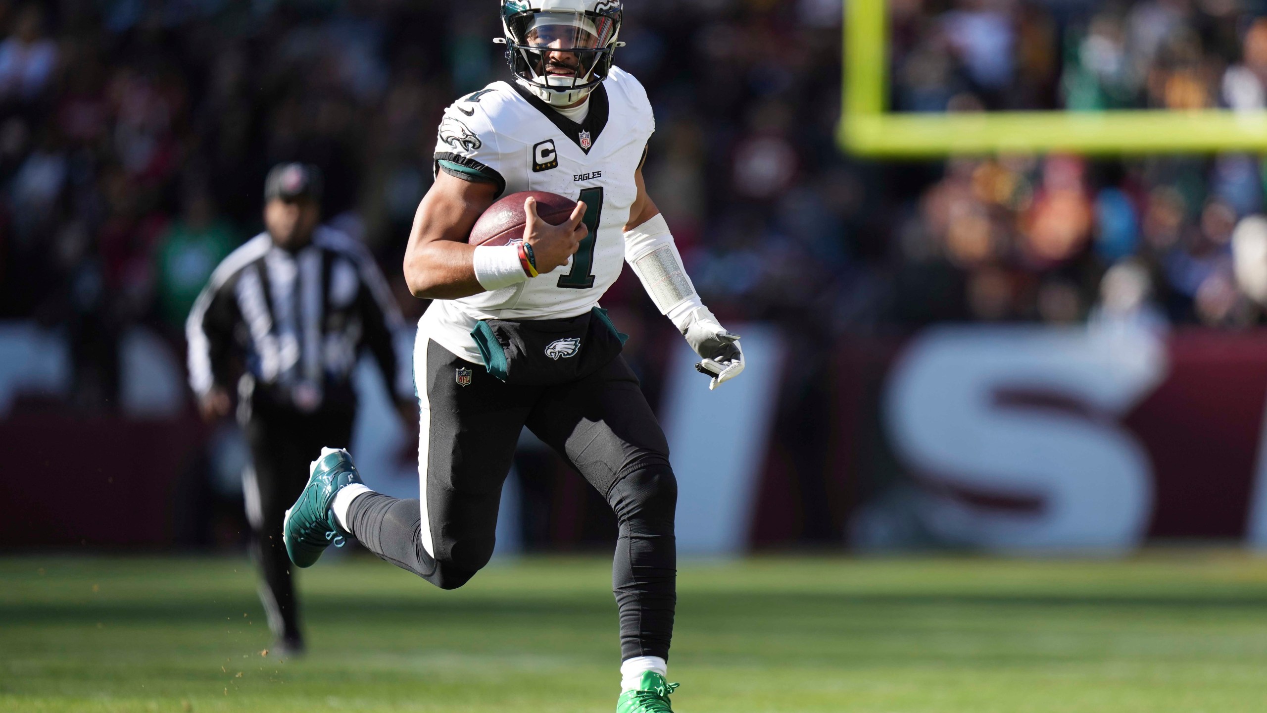 Philadelphia Eagles quarterback Jalen Hurts (1) running with the ball during the first half of an NFL football game against the Washington Commanders, Sunday, Dec. 22, 2024, in Landover, Md. (AP Photo/Stephanie Scarbrough)