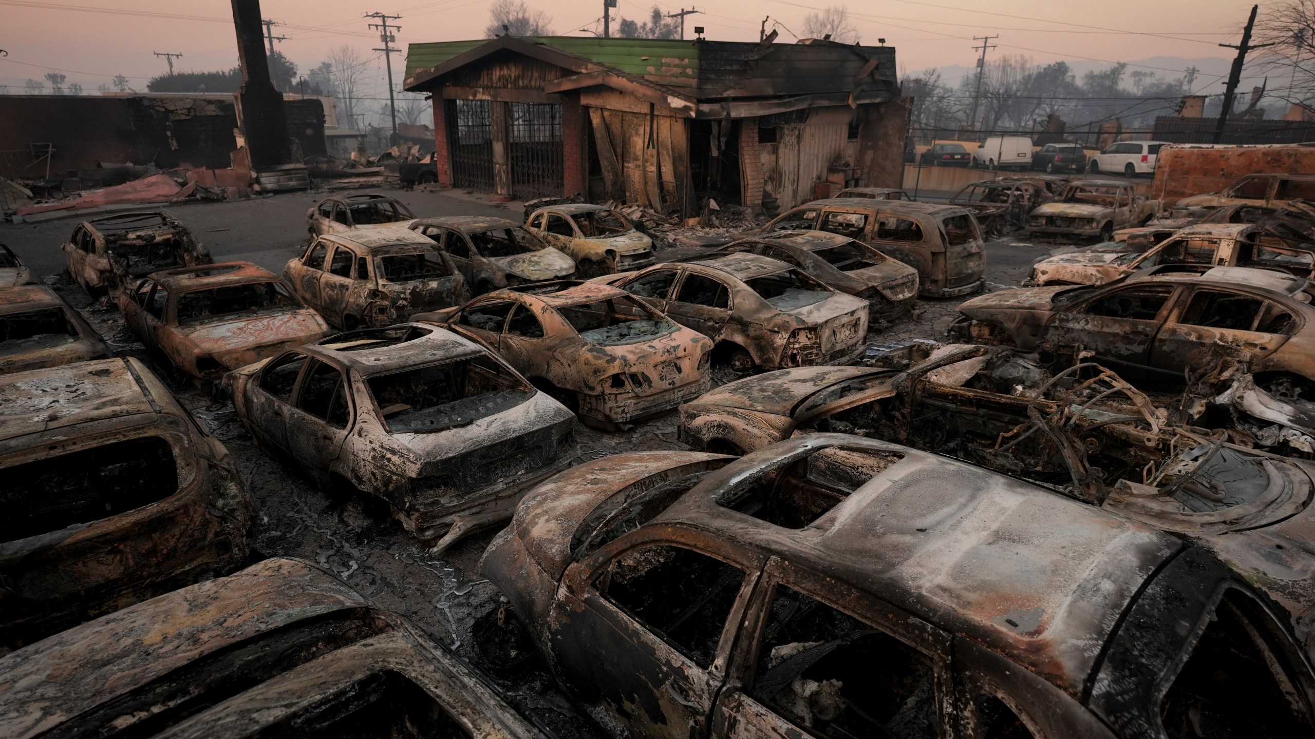 Cars are left charred inside a dealership in the aftermath of the Eaton Fire Friday, Jan. 10, 2025 in Altadena, Calif. (AP Photo/Jae C. Hong)