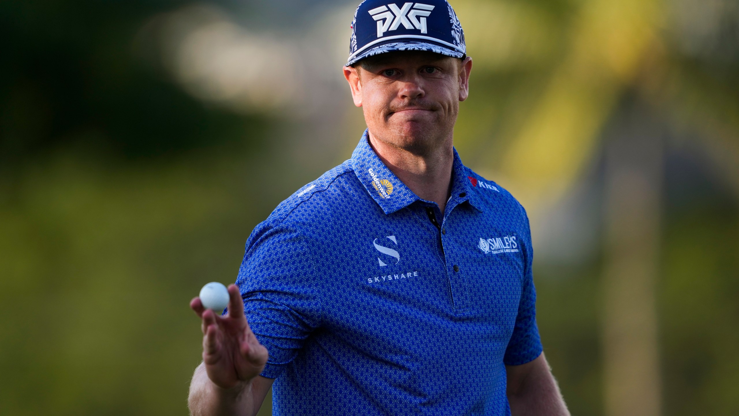 Patrick Fishburn reacts after making his shot on the ninth green during the second round of the Sony Open golf event, Friday, Jan. 10, 2025, at Waialae Country Club in Honolulu. (AP Photo/Matt York)