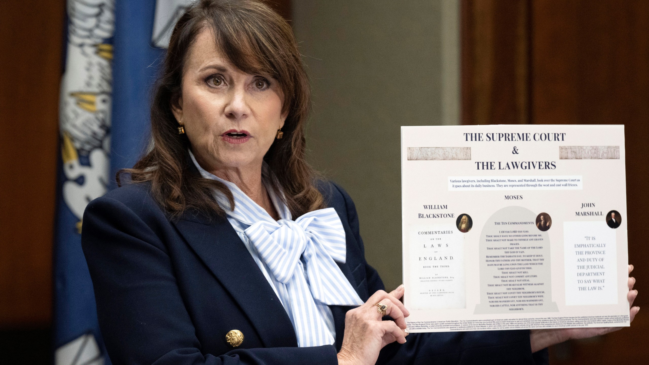 FILE - Louisiana Attorney General Liz Murrill holds up a mini-display showing the Ten Commandments during a press conference regarding the Ten Commandments in schools, Aug. 5, 2024, in Baton Rouge, La. (Hilary Scheinuk/The Advocate via AP, File)