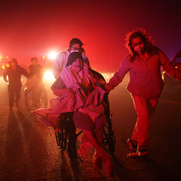 FILE - Residents of a senior center are evacuated as the Eaton Fire approaches Jan. 7, 2025, in Altadena, Calif. (AP Photo/Ethan Swope, File)