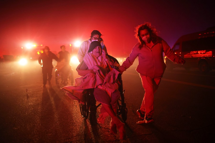 FILE - Residents of a senior center are evacuated as the Eaton Fire approaches Jan. 7, 2025, in Altadena, Calif. (AP Photo/Ethan Swope, File)