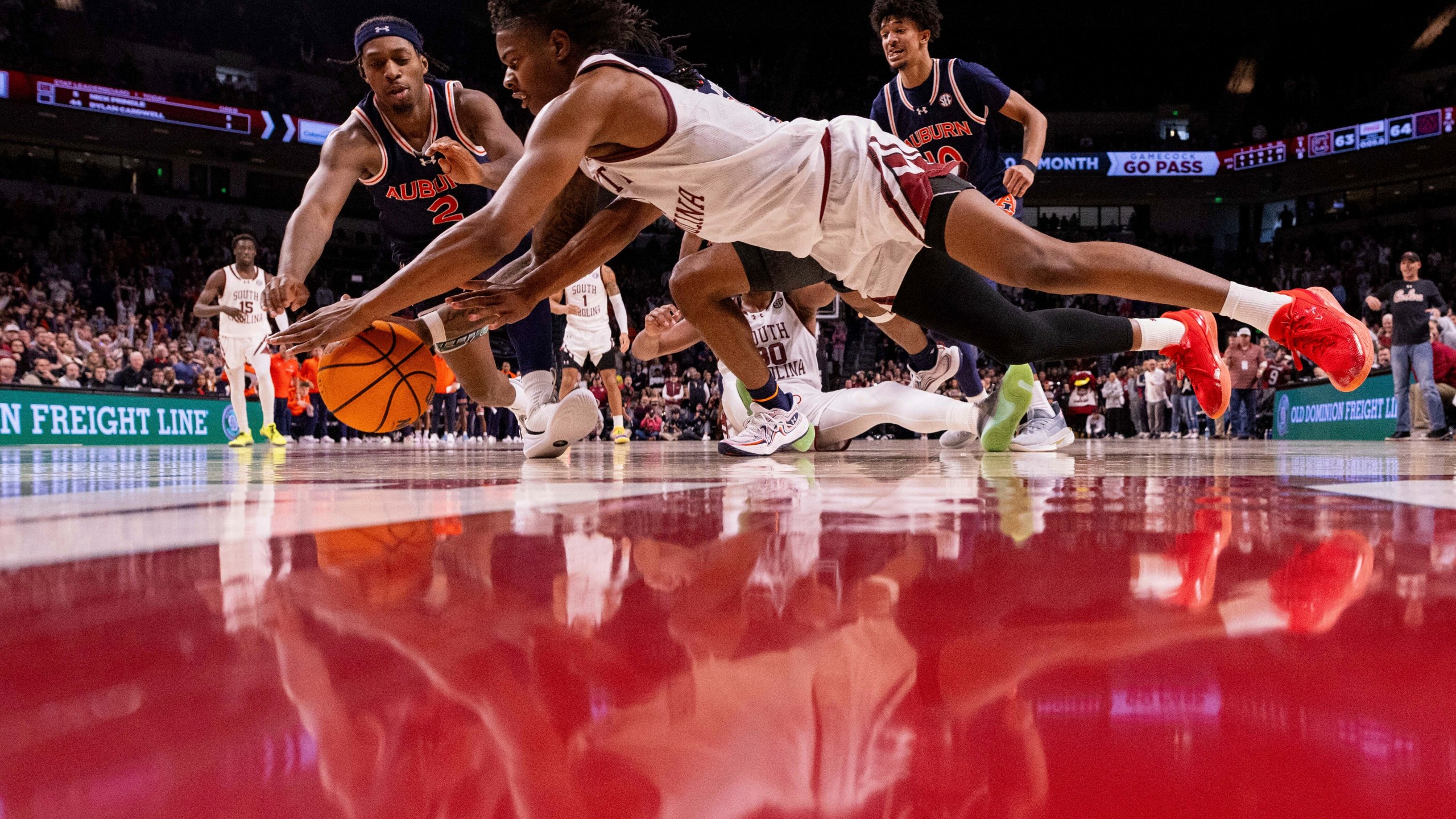 South Carolina forward Nick Pringle (5) and Auburn guard Denver Jones (2) dive for a loose ball during the second half of an NCAA college basketball game on Saturday, Jan. 11, 2025, in Columbia, S.C. (AP Photo/Scott Kinser)