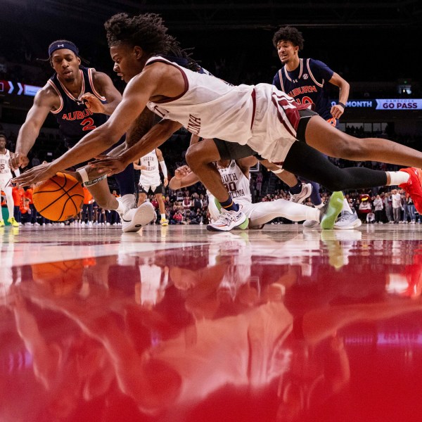 South Carolina forward Nick Pringle (5) and Auburn guard Denver Jones (2) dive for a loose ball during the second half of an NCAA college basketball game on Saturday, Jan. 11, 2025, in Columbia, S.C. (AP Photo/Scott Kinser)