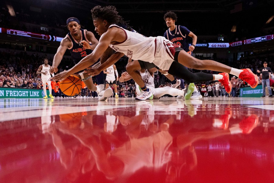 South Carolina forward Nick Pringle (5) and Auburn guard Denver Jones (2) dive for a loose ball during the second half of an NCAA college basketball game on Saturday, Jan. 11, 2025, in Columbia, S.C. (AP Photo/Scott Kinser)