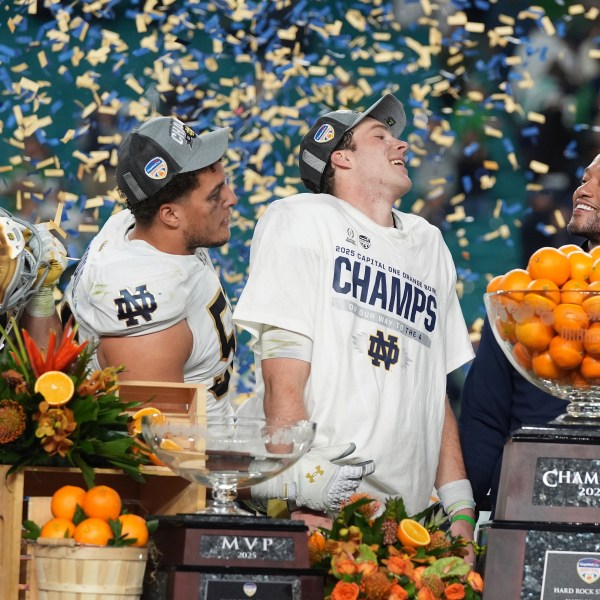 Notre Dame head coach Marcus Freeman and members of the team celebrate after winning the Orange Bowl College Football Playoff semifinal game against Penn State, Thursday, Jan. 9, 2025, in Miami Gardens, Fla. (AP Photo/Lynne Sladky)