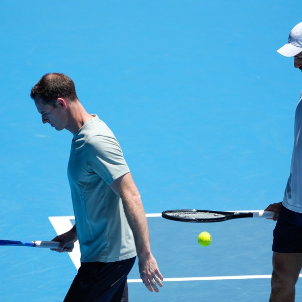 Serbia's Novak Djokovic walks with his coach Andy Murray, left, during a practice session ahead of the Australian Open tennis championship in Melbourne, Australia, Saturday, Jan. 11, 2025. (AP Photo/Ng Han Guan)