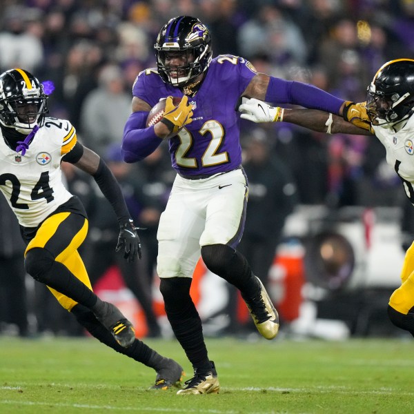 Baltimore Ravens running back Derrick Henry (22) breaks away from Pittsburgh Steelers linebacker Patrick Queen (6) and cornerback Joey Porter Jr. (24) on his way to scoring a rushing touchdown during the second half of an NFL wild-card playoff football game, Saturday, Jan. 11, 2025, in Baltimore. (AP Photo/Stephanie Scarbrough)