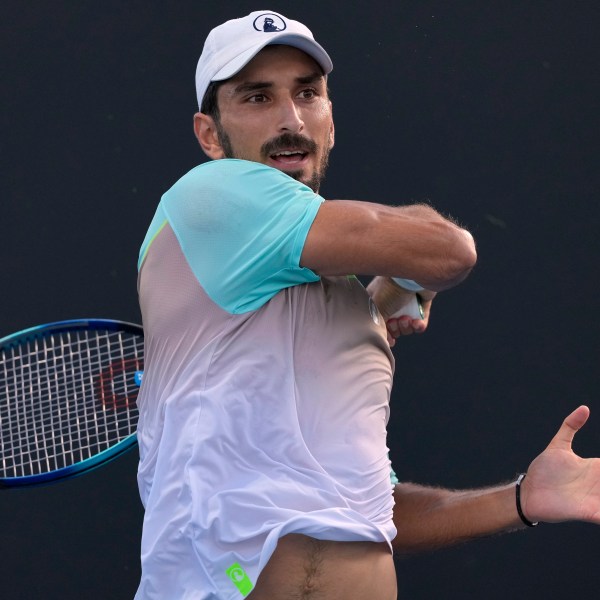 Hady Habib of Lebanon plays a forehand return to Bu Yunchaokete of China during their first round match at the Australian Open tennis championship in Melbourne, Australia, Sunday, Jan. 12, 2025. (AP Photo/Asanka Brendon Ratnayake)