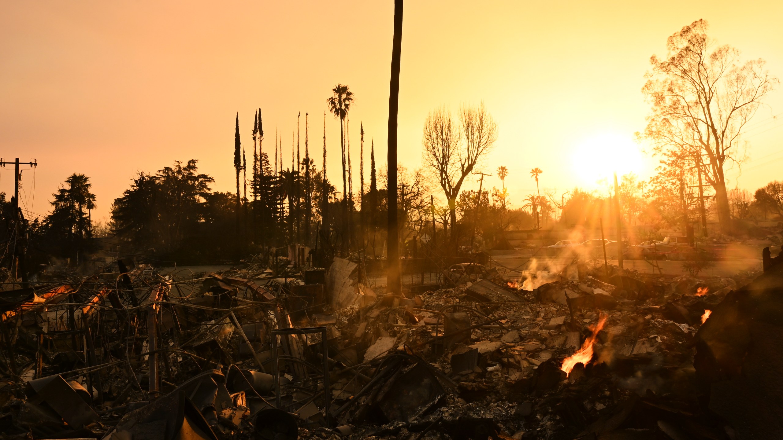 The sun sets over damage from the Eaton Fire, Thursday, Jan. 9, 2025, in Altadena, Calif. (AP Photo/Nic Coury)