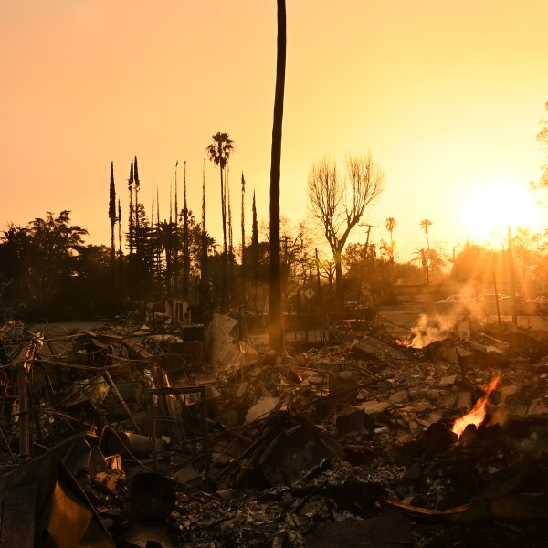 The sun sets over damage from the Eaton Fire, Thursday, Jan. 9, 2025, in Altadena, Calif. (AP Photo/Nic Coury)