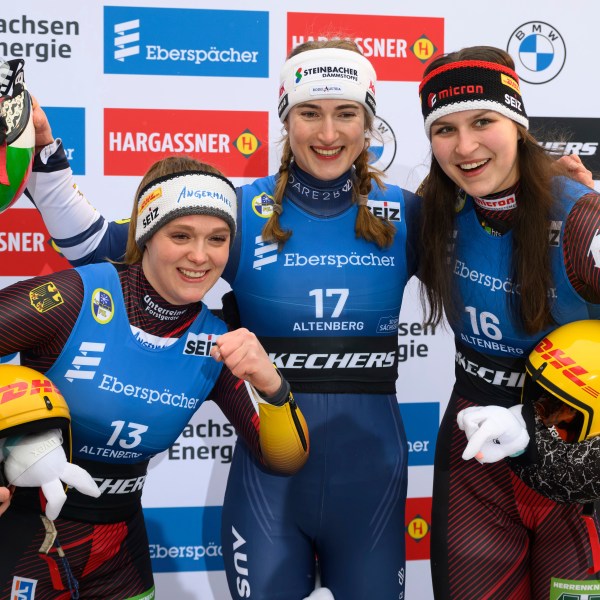 Winner Madeleine Egle from Austria, center, second placed Anna Berreiter, left, and third placed Merle Frobel, both from Germany, celebrate after the women's single-seater 2nd run at the Luge World Cup in Altenberg, Germany, Sunday Jan. 12, 2025. (Robert Michael/dpa via AP)