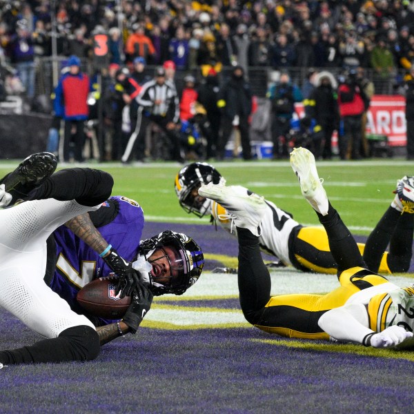 Baltimore Ravens wide receiver Rashod Bateman, left, catches a touchdown pass from quarterback Lamar Jackson, not visible, in front of Pittsburgh Steelers cornerback Donte Jackson (26) and cornerback Cameron Sutton during the first half of an NFL wild-card playoff football game, Saturday, Jan. 11, 2025, in Baltimore. (AP Photo/Nick Wass)