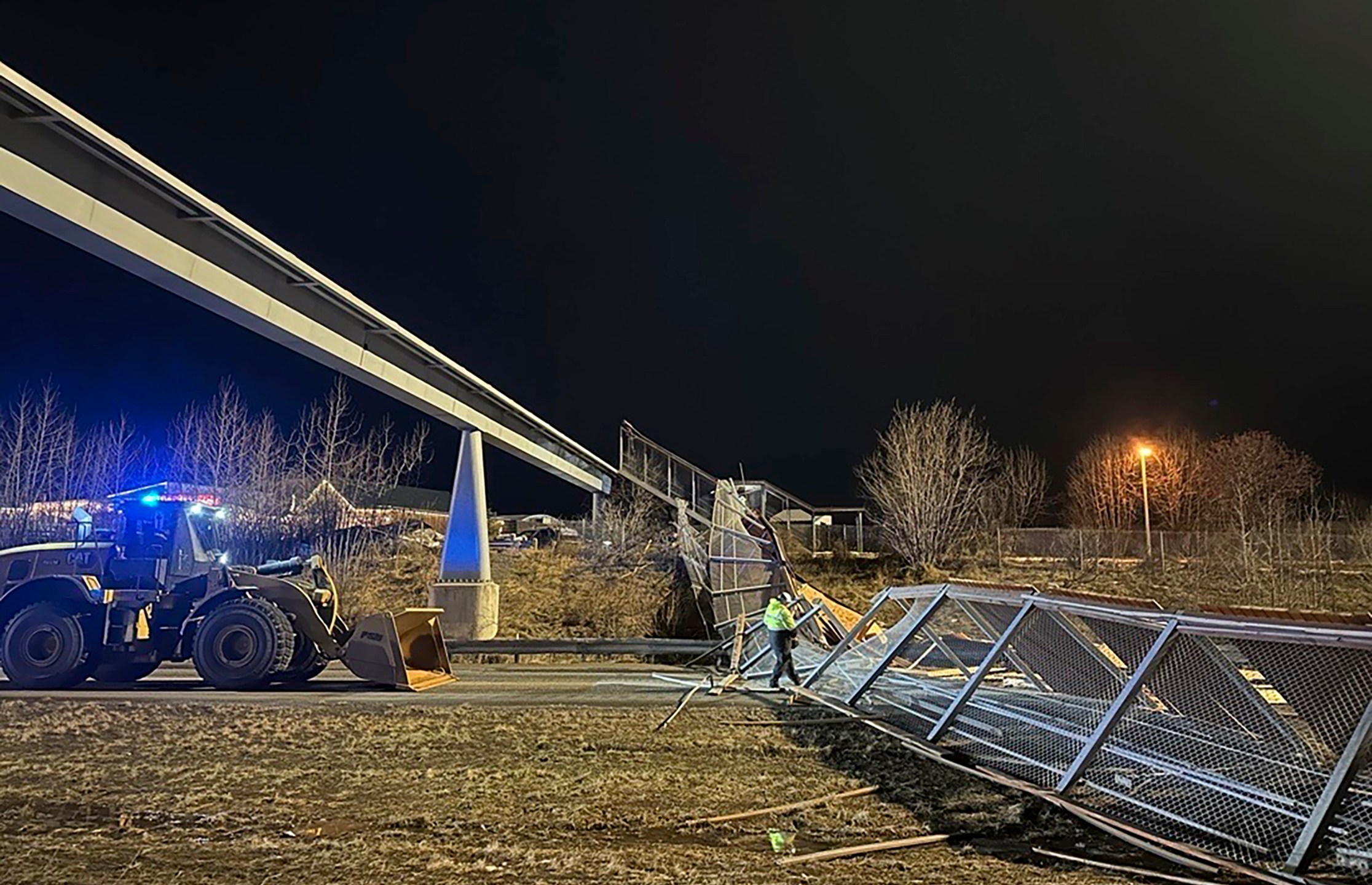 This image provided by the Alaska Department of Transportation & Public Facilities shows fencing and the roof of a walkway after collapsing onto the Seward Highway in Anchorage, Alaska, on Sunday, Jan. 12, 2025. (Alaska Department of Transportation & Public Facilities via AP)