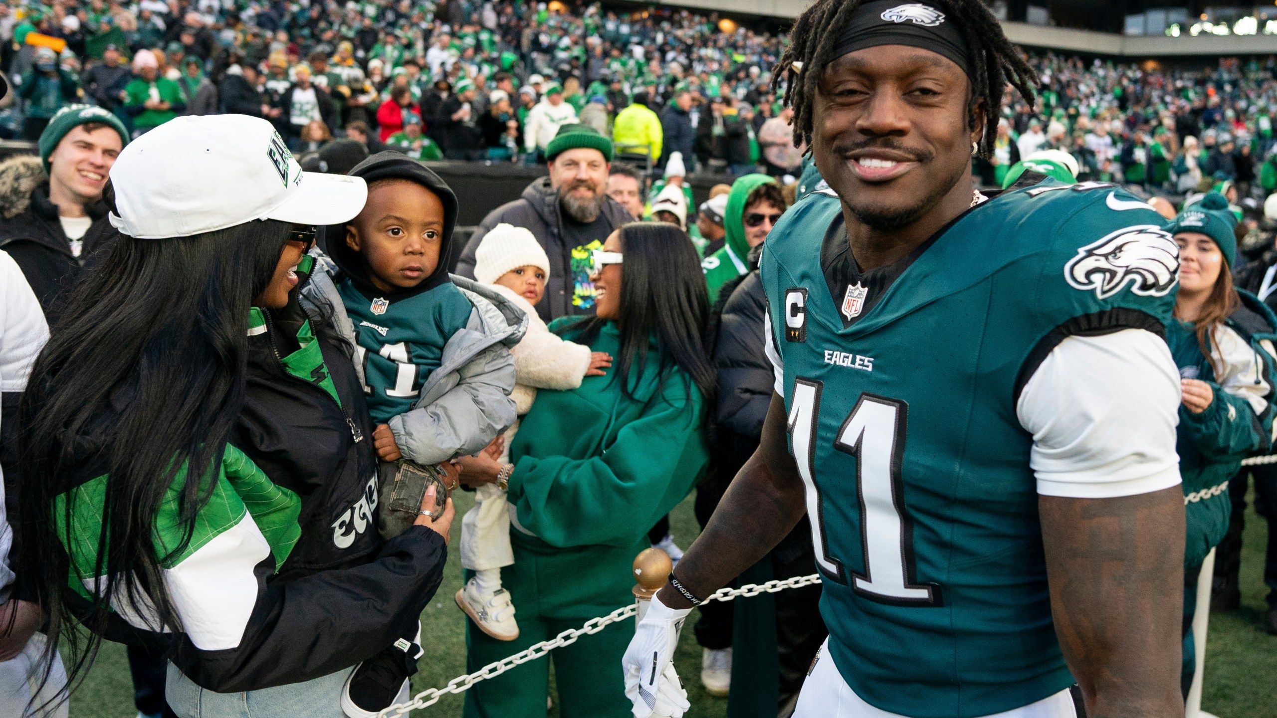 Philadelphia Eagle wide receiver A.J. Brown (11) looks on after talking with his son before an NFL wild-card playoff football game against the Green Bay Packers, Sunday, Jan. 12, 2025, in Philadelphia. (AP Photo/Chris Szagola)