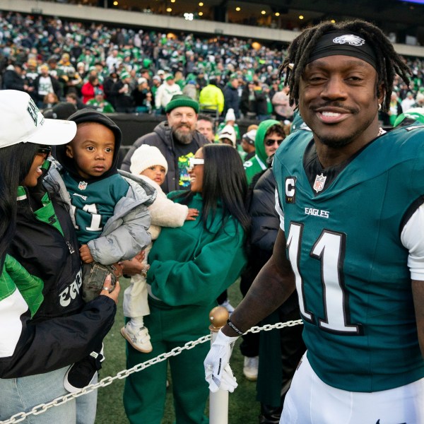 Philadelphia Eagle wide receiver A.J. Brown (11) looks on after talking with his son before an NFL wild-card playoff football game against the Green Bay Packers, Sunday, Jan. 12, 2025, in Philadelphia. (AP Photo/Chris Szagola)