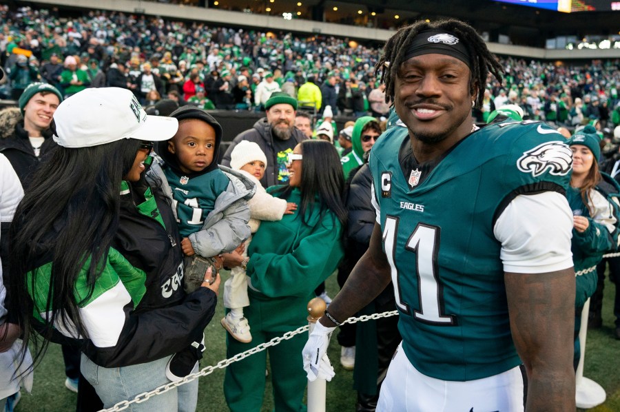 Philadelphia Eagle wide receiver A.J. Brown (11) looks on after talking with his son before an NFL wild-card playoff football game against the Green Bay Packers, Sunday, Jan. 12, 2025, in Philadelphia. (AP Photo/Chris Szagola)