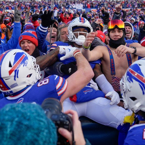 Buffalo Bills wide receiver Curtis Samuel (1) celebrates with fans after scoring a touchdown against the Denver Broncos during the fourth quarter of an NFL wild card playoff football game, Sunday, Jan. 12, 2025, in Orchard Park, N.Y. (AP Photo/Seth Wenig)