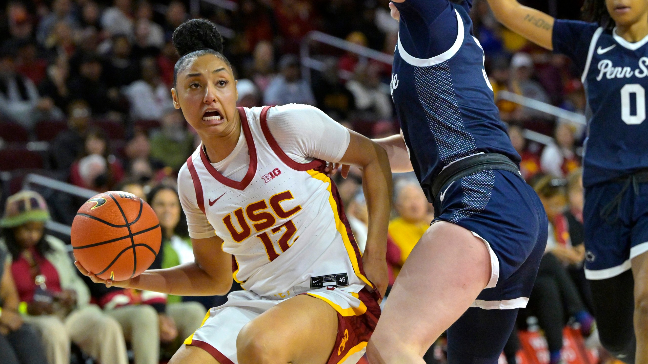 Southern California guard JuJu Watkins, left, drives past Penn State guard Moriah Murray, front right, during the second half of an NCAA college basketball game Sunday, Jan. 12, 2025, in Los Angeles. (AP Photo/Jayne Kamin-Oncea)