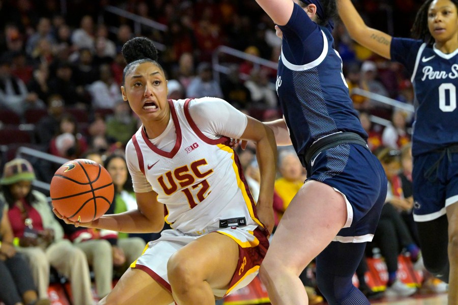 Southern California guard JuJu Watkins, left, drives past Penn State guard Moriah Murray, front right, during the second half of an NCAA college basketball game Sunday, Jan. 12, 2025, in Los Angeles. (AP Photo/Jayne Kamin-Oncea)