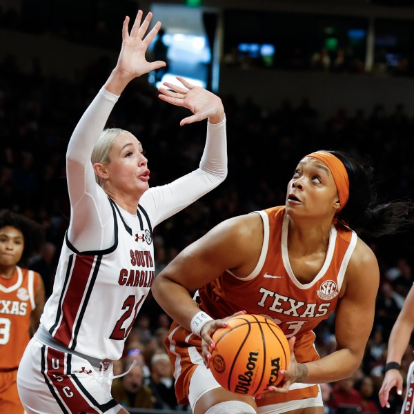 Texas forward Aaliyah Moore looks to shoot against South Carolina forward Chloe Kitts (21) during the second half of an NCAA college basketball game in Columbia, S.C., Sunday, Jan. 12, 2025. (AP Photo/Nell Redmond)