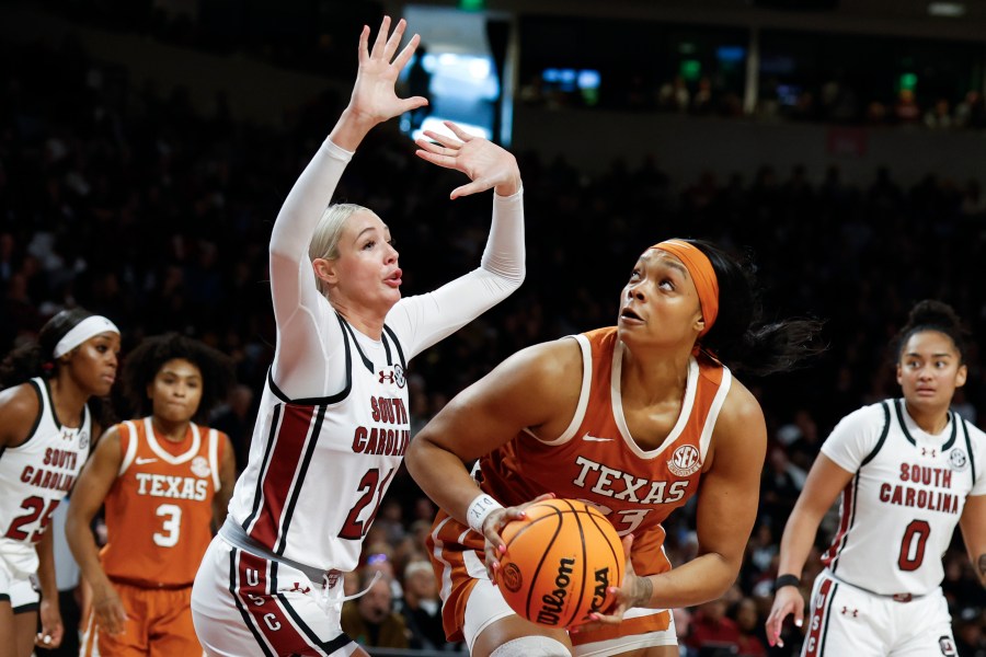 Texas forward Aaliyah Moore looks to shoot against South Carolina forward Chloe Kitts (21) during the second half of an NCAA college basketball game in Columbia, S.C., Sunday, Jan. 12, 2025. (AP Photo/Nell Redmond)