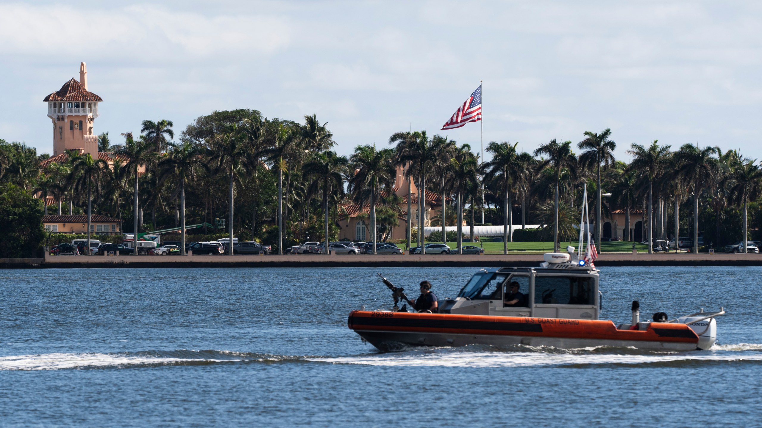 The U.S. flag is shown at the Mar-a-Lago compound in Palm Beach, Fla., while a U.S. Coast Guard boat patrols around the vicinity, Monday, Jan. 13, 2025. U.S. flags at President-elect Donald Trump's private Mar-a-Lago club are back to flying at full height. Flags are supposed to fly at half-staff through the end of January out of respect for former President Jimmy Carter, who died Dec. 29. (AP Photo/Manuel Balce Ceneta)