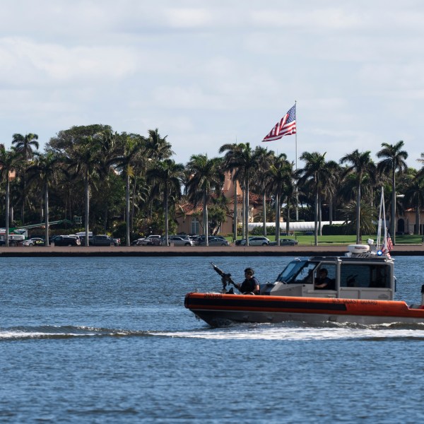 The U.S. flag is shown at the Mar-a-Lago compound in Palm Beach, Fla., while a U.S. Coast Guard boat patrols around the vicinity, Monday, Jan. 13, 2025. U.S. flags at President-elect Donald Trump's private Mar-a-Lago club are back to flying at full height. Flags are supposed to fly at half-staff through the end of January out of respect for former President Jimmy Carter, who died Dec. 29. (AP Photo/Manuel Balce Ceneta)