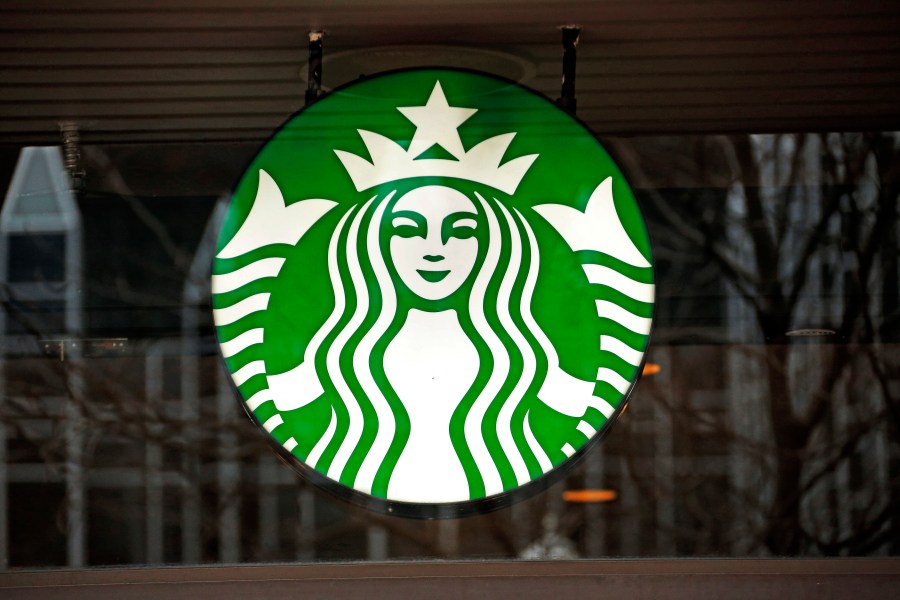 FILE - A Starbucks logo sign in the window of one of the chain's cafes in Pittsburgh, Jan. 12, 2017. (AP Photo/Gene J. Puskar, File)