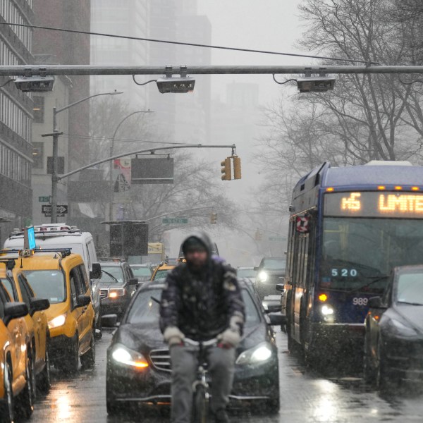 Devices used for congestion tolling hang above traffic on a Manhattan street in New York, Monday, Jan. 6, 2025. (AP Photo/Seth Wenig)