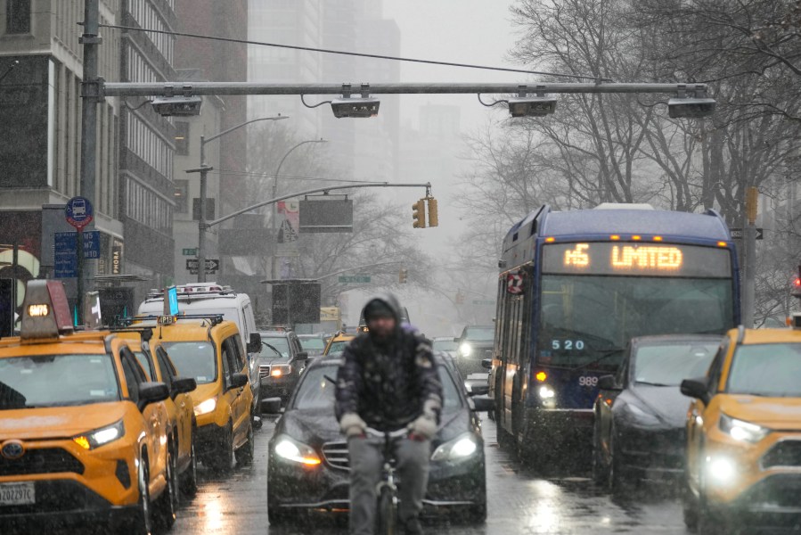 Devices used for congestion tolling hang above traffic on a Manhattan street in New York, Monday, Jan. 6, 2025. (AP Photo/Seth Wenig)