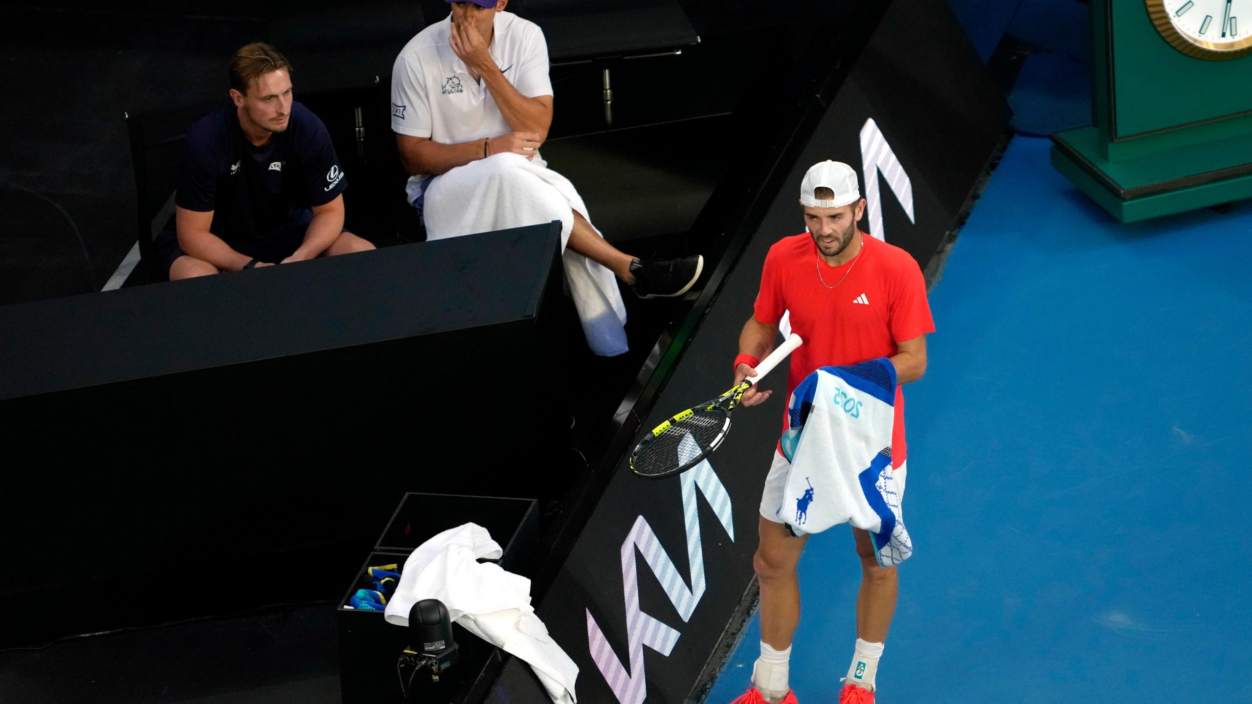 Jacob Fearnley of Britain stands by his coaches box during their first round match against Nick Kyrgios of Australia at the Australian Open tennis championship in Melbourne, Australia, Monday, Jan. 13, 2025. (AP Photo/Ng Han Guan)