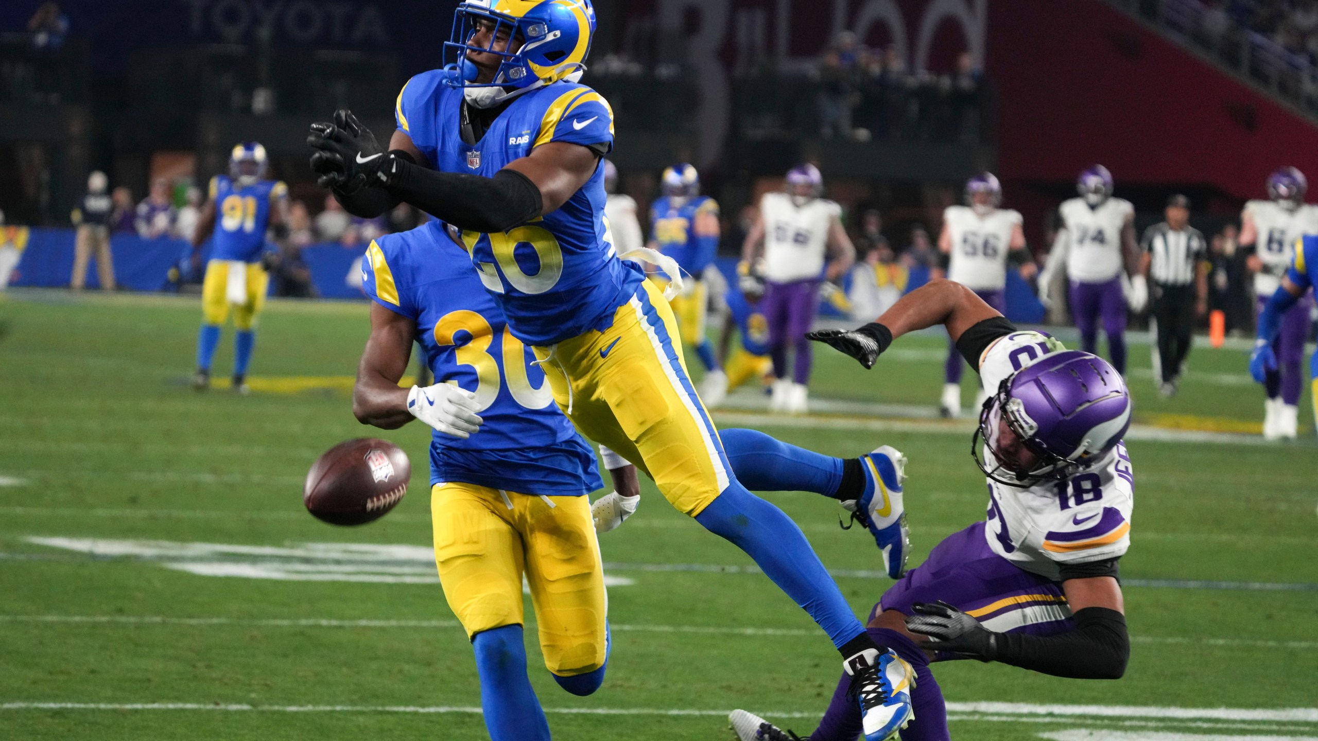 Los Angeles Rams safety Kamren Kinchens (26) defends a pass intended for Minnesota Vikings wide receiver Justin Jefferson (18) during the second half of an NFL wild card playoff football game, Monday, Jan. 13, 2025, in Glendale, Ariz. (AP Photo/Rick Scuteri)