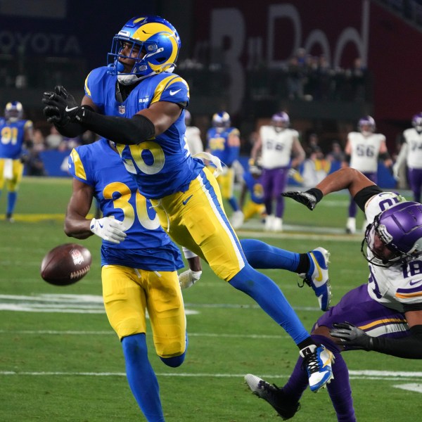 Los Angeles Rams safety Kamren Kinchens (26) defends a pass intended for Minnesota Vikings wide receiver Justin Jefferson (18) during the second half of an NFL wild card playoff football game, Monday, Jan. 13, 2025, in Glendale, Ariz. (AP Photo/Rick Scuteri)