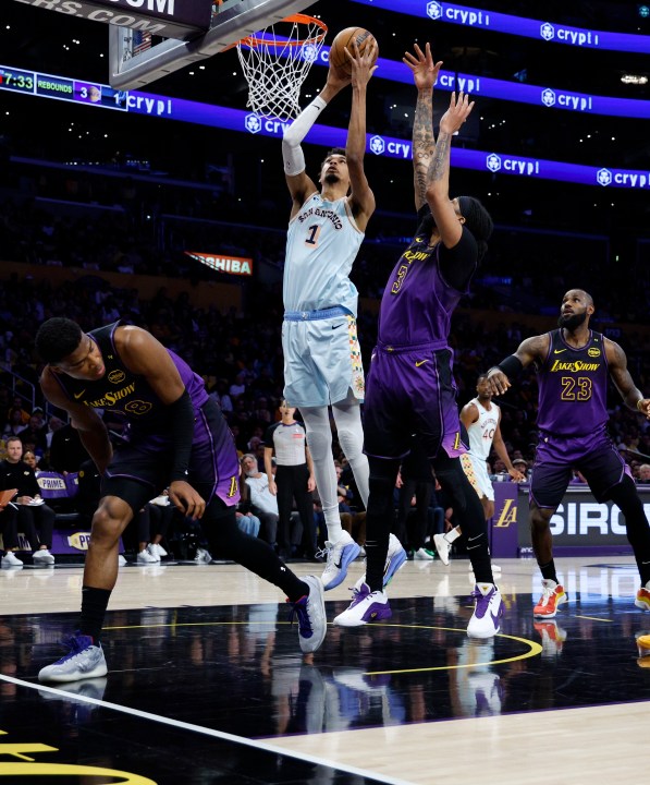 San Antonio Spurs center Victor Wembanyama (1) goes up to score against Los Angeles Lakers forward Anthony Davis (3) during the first quarter of an NBA basketball game Monday, Jan. 13, 2025, in Los Angeles. (AP Photo/Kevork Djansezian)