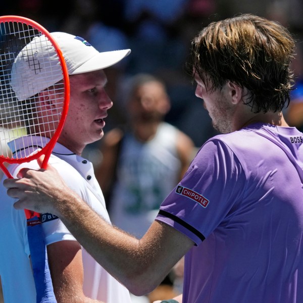 Taylor Fritz, right, of the U.S. is congratulated by compatriot Jenson Brooksby following their first round match at the Australian Open tennis championship in Melbourne, Australia, Tuesday, Jan. 14, 2025. (AP Photo/Vincent Thian)