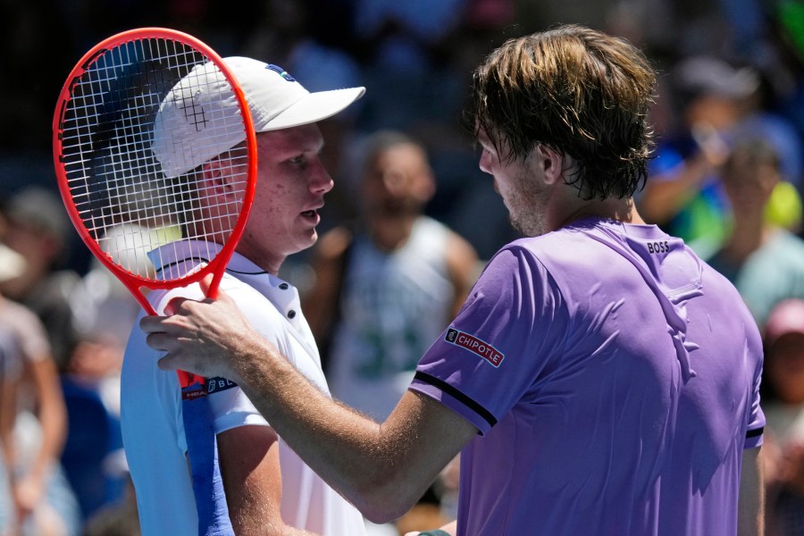 Taylor Fritz, right, of the U.S. is congratulated by compatriot Jenson Brooksby following their first round match at the Australian Open tennis championship in Melbourne, Australia, Tuesday, Jan. 14, 2025. (AP Photo/Vincent Thian)