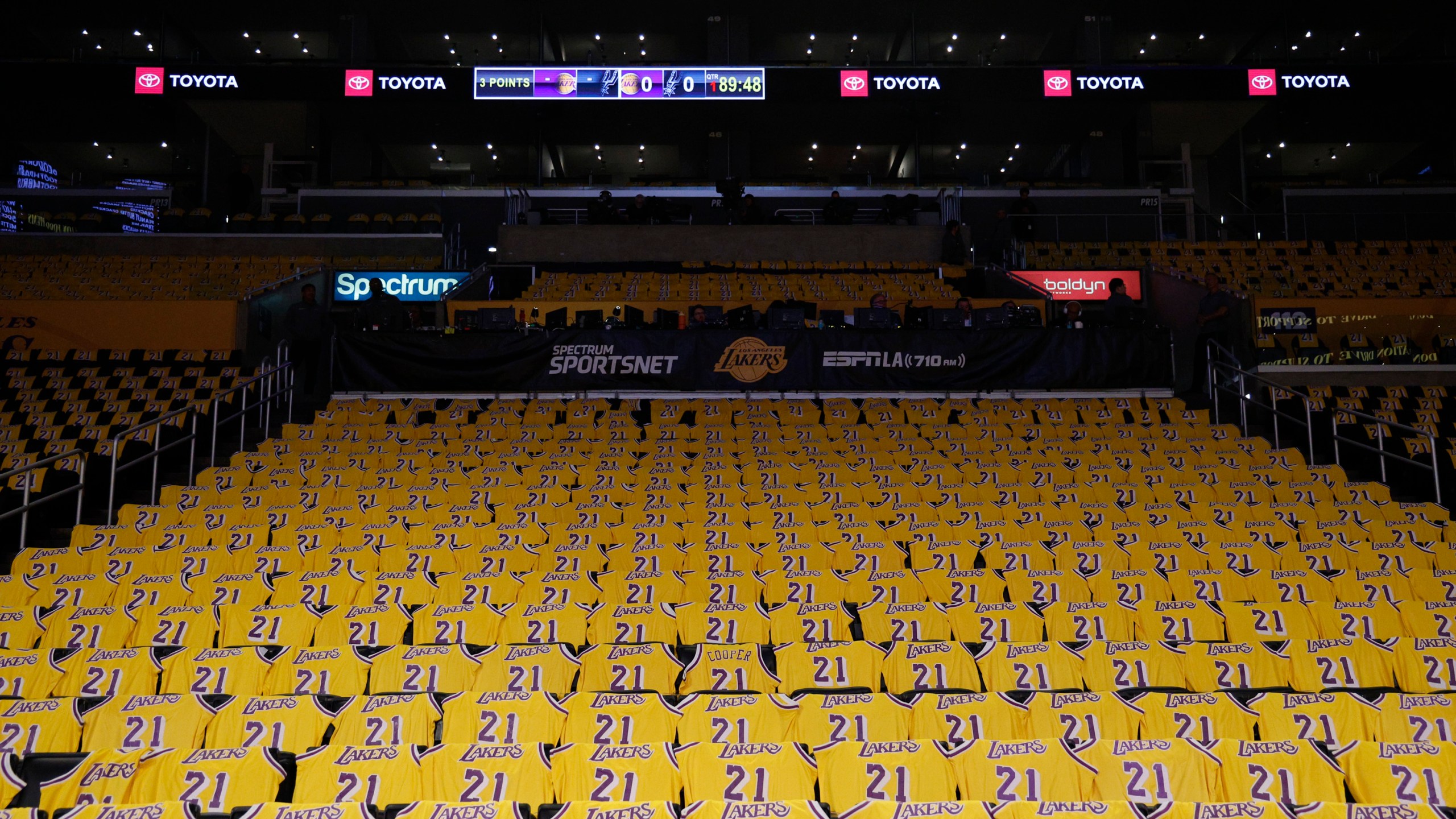 Jerseys with the number of former Los Angeles Lakers player Michel Cooper are left for fans on seats before an NBA basketball game between the Lakers and the San Antonio Spurs, Monday, Jan. 13, 2025, in Los Angeles. Cooper's No. 21 jersey will be raised into the rafters during halftime. (AP Photo/Kevork Djansezian)