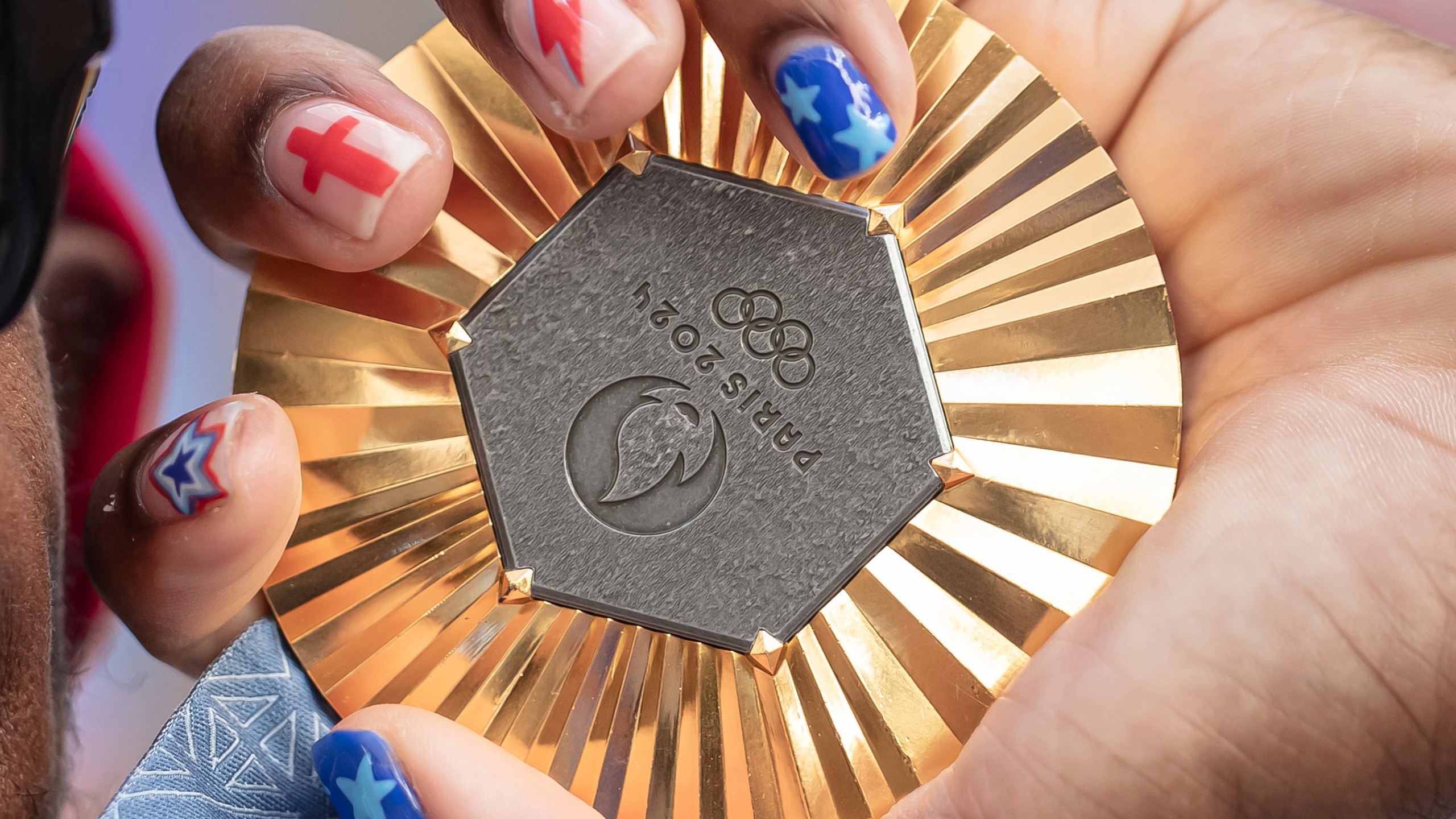 FILE - American Olympic champion Noah Lyles holds this gold medal before an interview in Paris, France, Sunday, Aug. 11, 2024. (AP Photo/Aurelien Morissard, File)