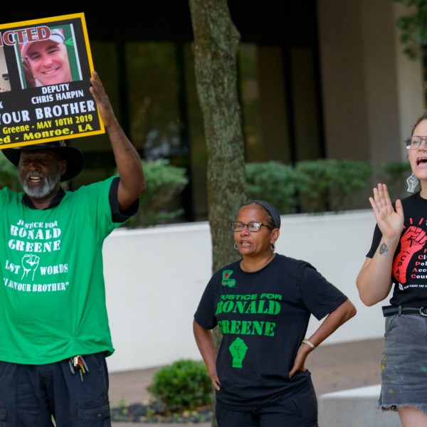 FILE - From left, Lumumba Lutalo, Angela "Mama Ghost" Green and Antonia Mar, of New Orleans for Community Oversight of Police, take part in a rally for justice for Ronald Greene at the Eastern District of Louisiana Courthouse in New Orleans, on May 10, 2024. (AP Photo/Matthew Hinton, File)