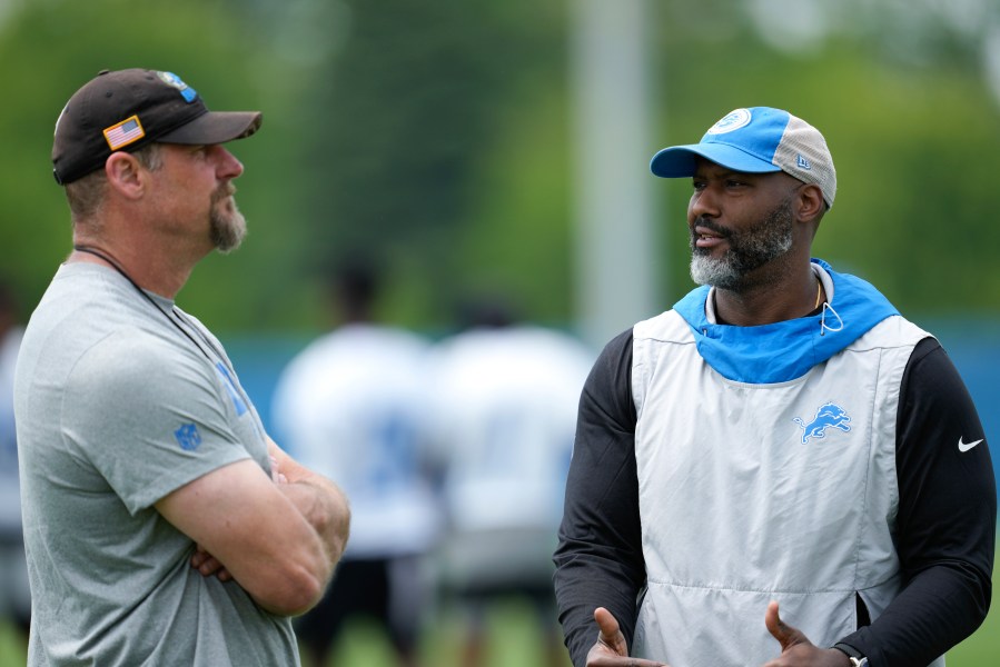 FILE - Detroit Lions head coach Dan Campbell, left, and general manager Brad Holmes, right, talk after an NFL football practice in Allen Park, Mich., June 6, 2023. (AP Photo/Paul Sancya, file)