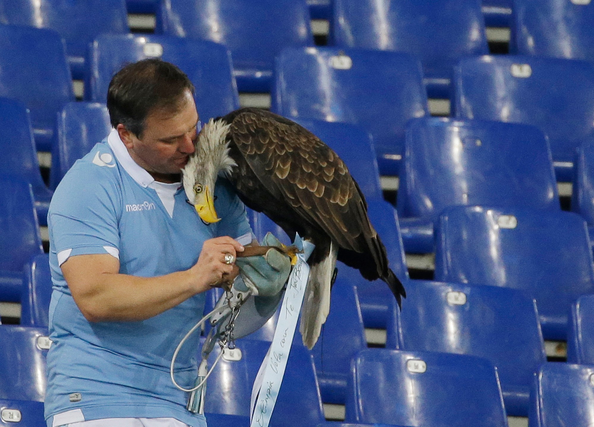 FILE - Lazio's mascot Olympia is recovered by falconer Juan Bernabe after escaping prior to the start of a Serie A soccer match between Lazio and AC Milan at Rome's Olympic stadium, Saturday, Jan. 24, 2015. (AP Photo/Gregorio Borgia, File)