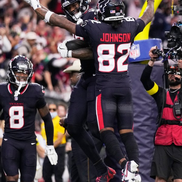 Houston Texans wide receiver Nico Collins, rear, celebrates with Diontae Johnson (82) after scoring a touchdown against the Los Angeles Chargers during the first half of an NFL wild-card playoff football game Saturday, Jan. 11, 2025, in Houston. (AP Photo/Eric Christian Smith)