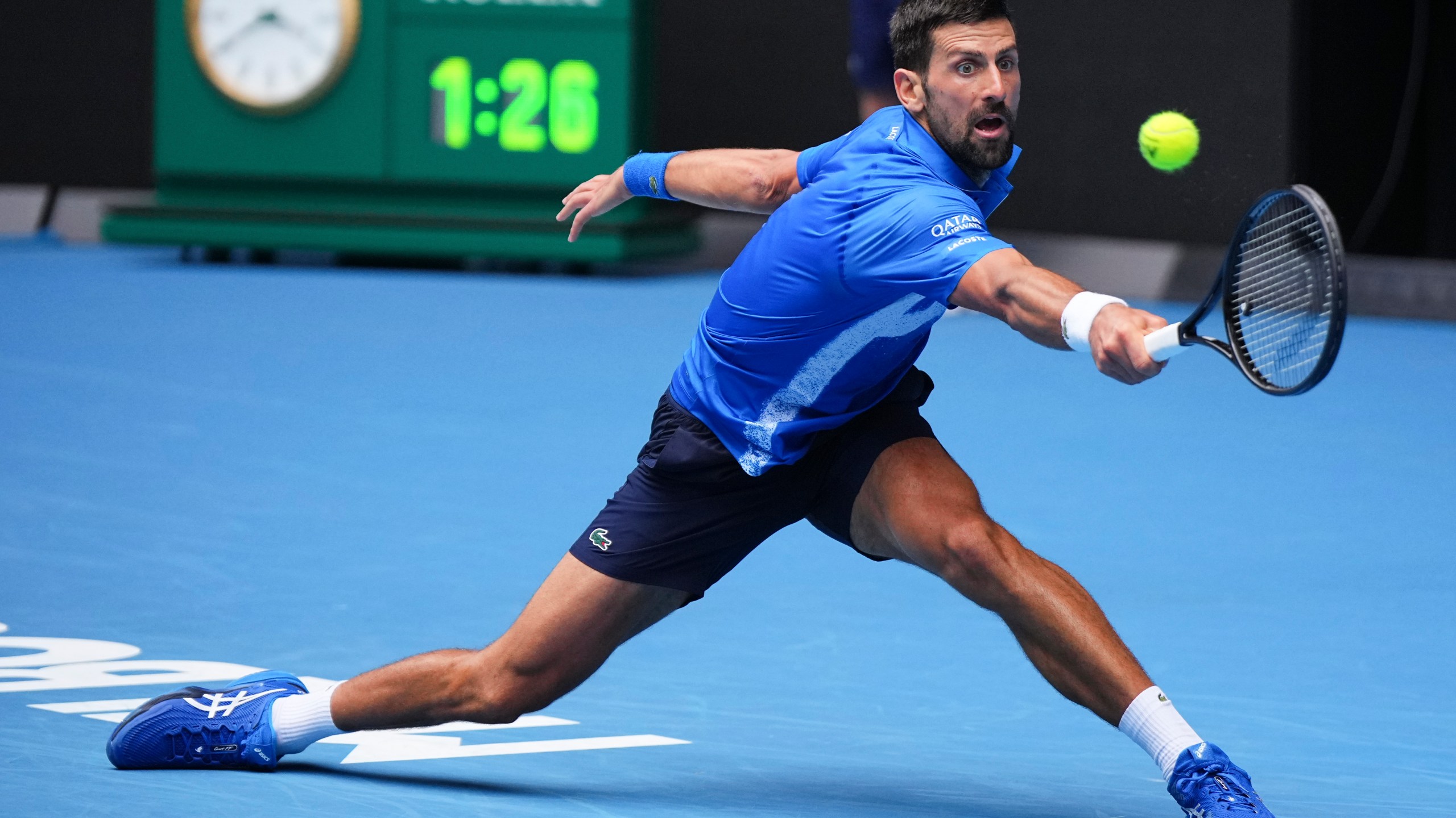 Novak Djokovic of Serbia plays a backhand return to Jaime Faria of Portugal during their second round match at the Australian Open tennis championship in Melbourne, Australia, Wednesday, Jan. 15, 2025. (AP Photo/Vincent Thian)