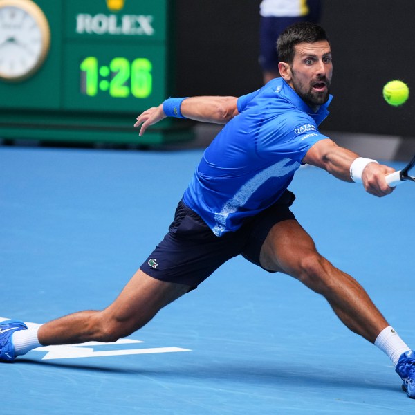 Novak Djokovic of Serbia plays a backhand return to Jaime Faria of Portugal during their second round match at the Australian Open tennis championship in Melbourne, Australia, Wednesday, Jan. 15, 2025. (AP Photo/Vincent Thian)