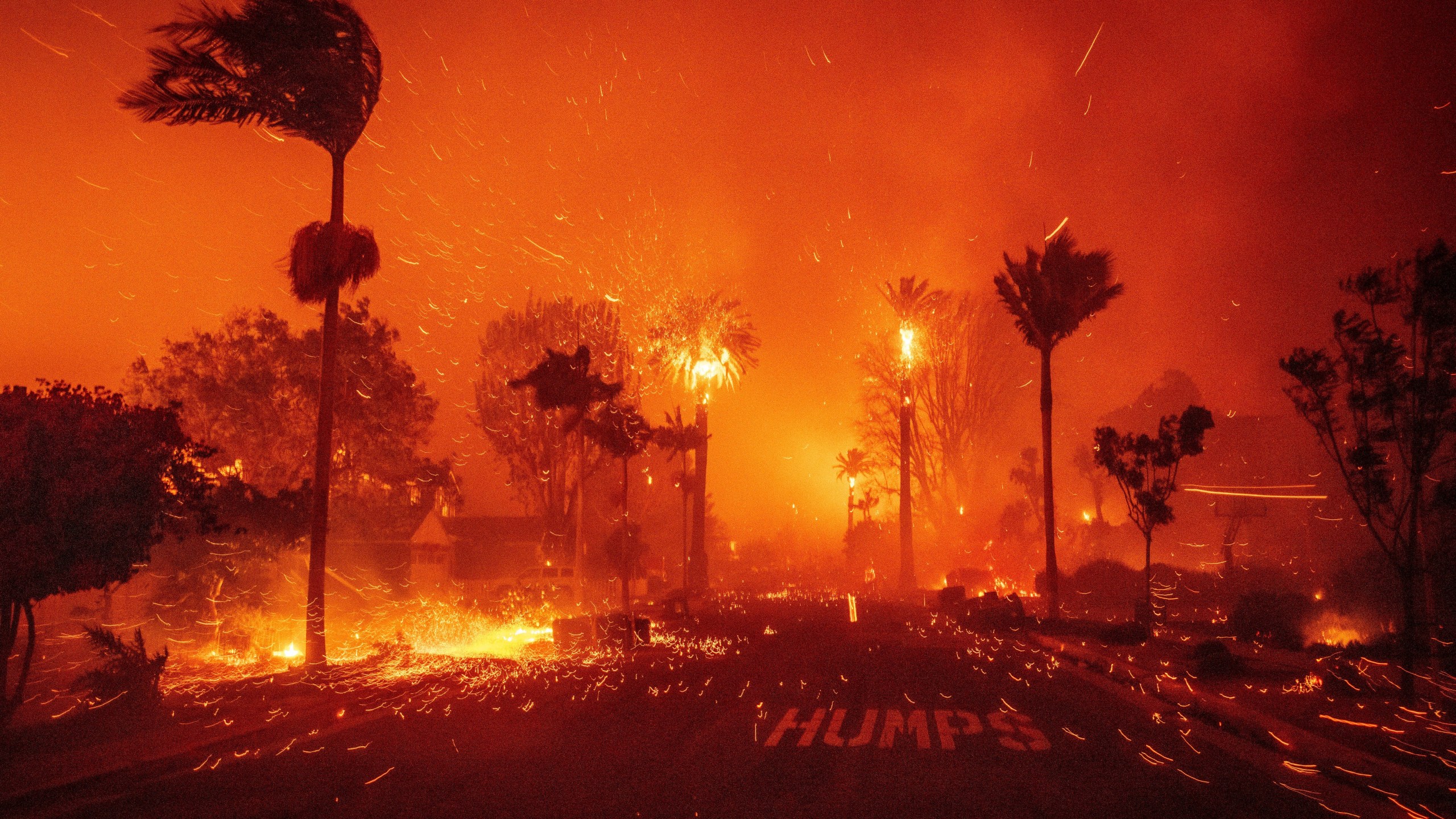 The Palisades Fire ravages a neighborhood amid high winds in the Pacific Palisades neighborhood of Los Angeles, Jan. 7, 2025. (AP Photo/Ethan Swope)